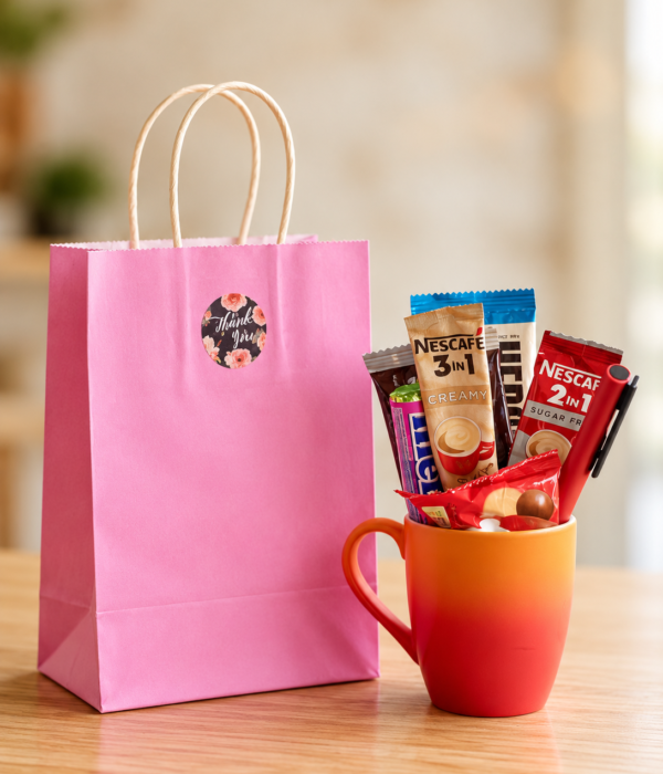 Pink Coffee Treats Gift Set with pink thank-you bag, orange-red ceramic mug, Nescafé coffee sachets and chocolates